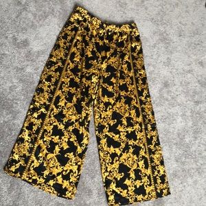 Satin wide legged “Versace” print pants